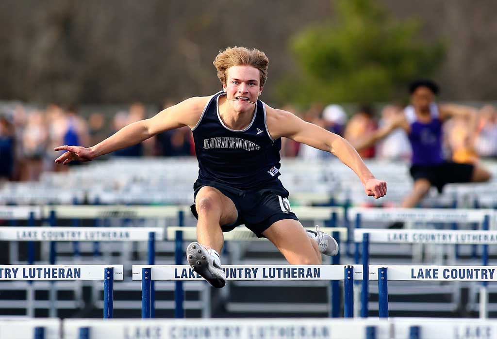 student athlete hurdling