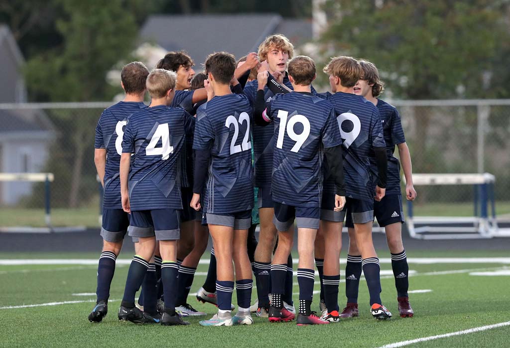 soccer team huddling